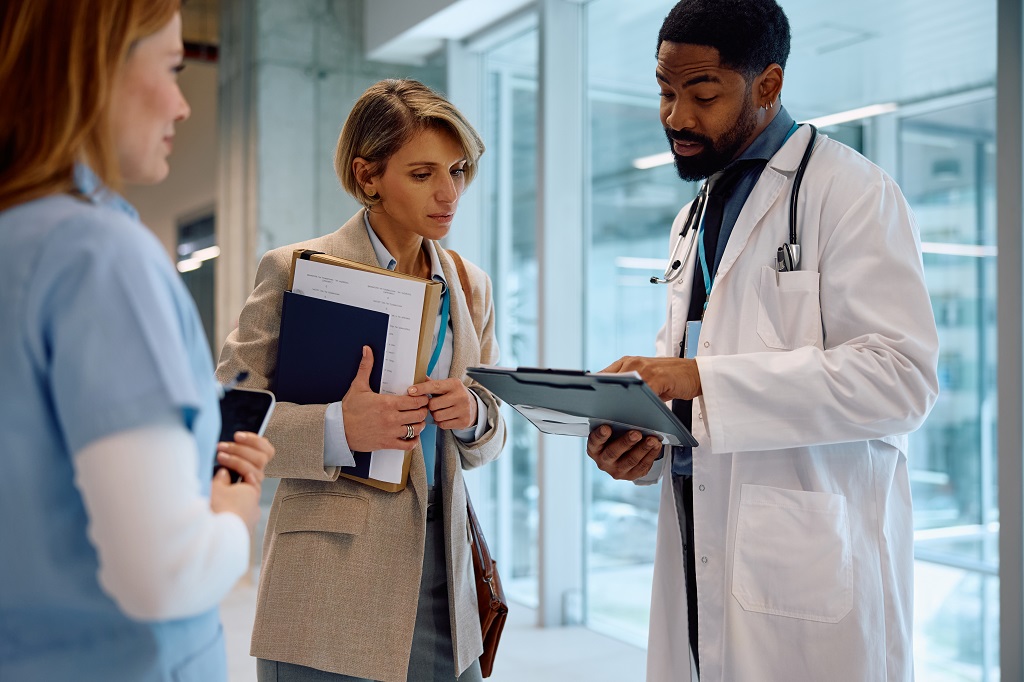 Medical consultant explaining insurance documents to clients at US Health Advisors