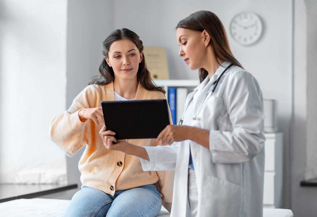 Doctor reviewing health insurance information with a patient during consultation
