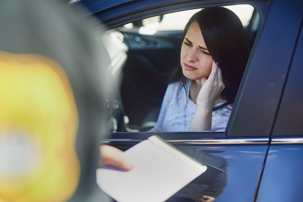 Driver speaking with police officer during traffic stop after refusing a Blood Alcohol Test
