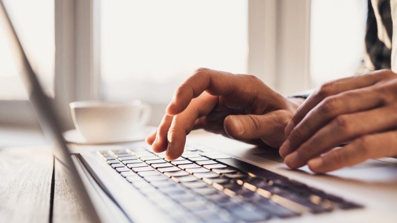 Employee typing on a keyboard while using a work computer