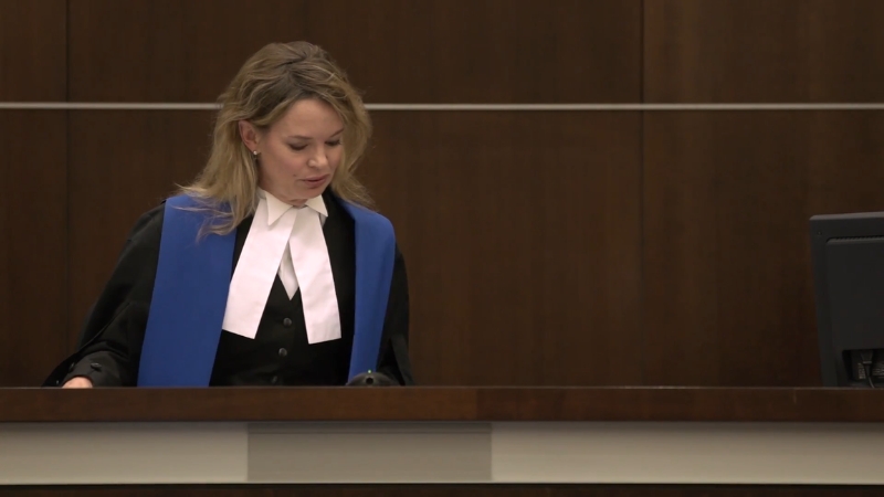 Judge reviewing documents at the bench during a small claims court hearing