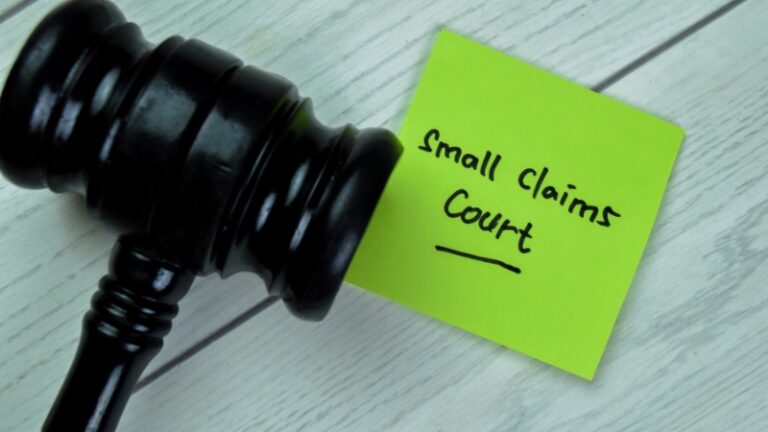 Judge’s gavel next to a note labeled small claims court on a desk