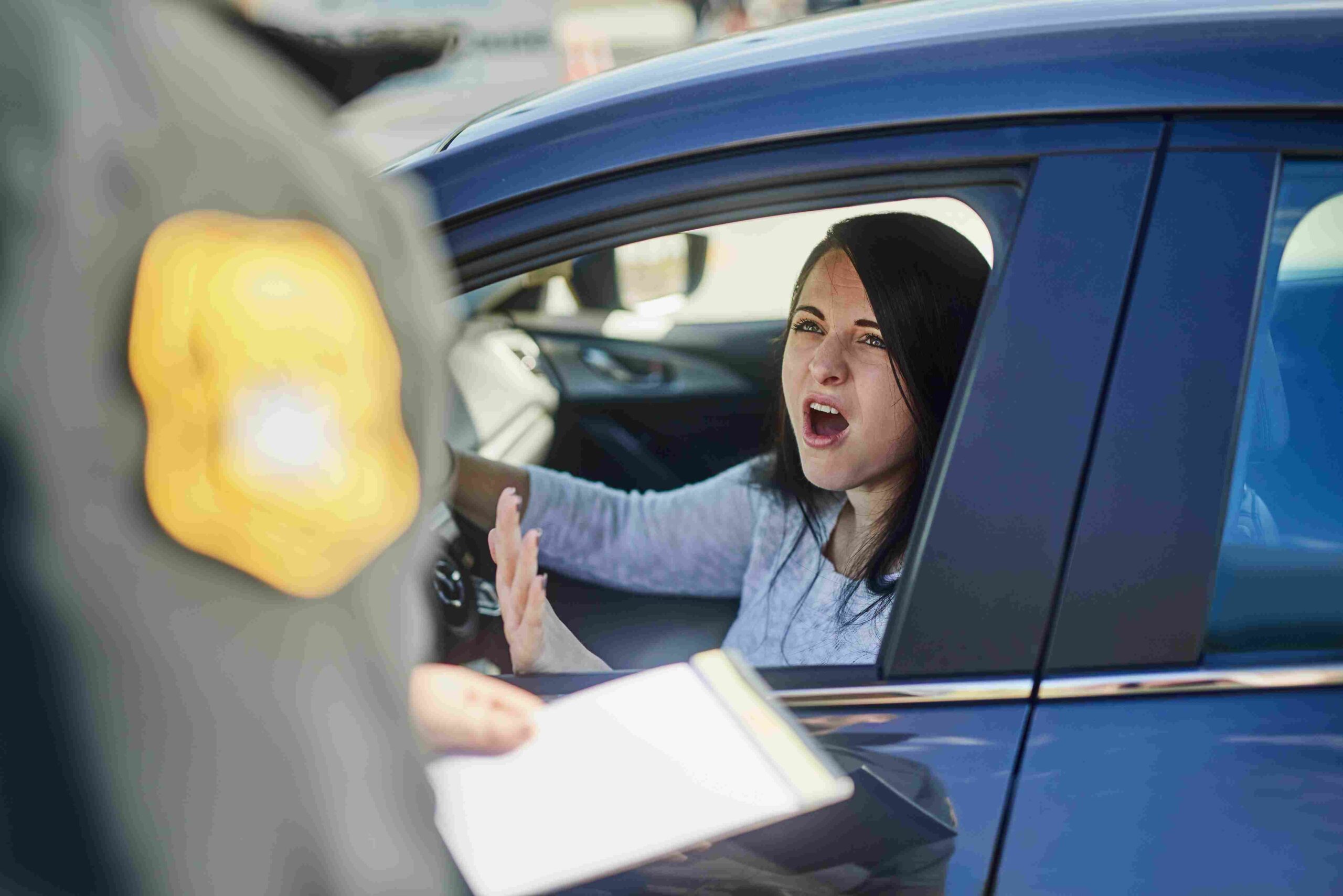 Driver speaking angrily to a police officer during a traffic stop